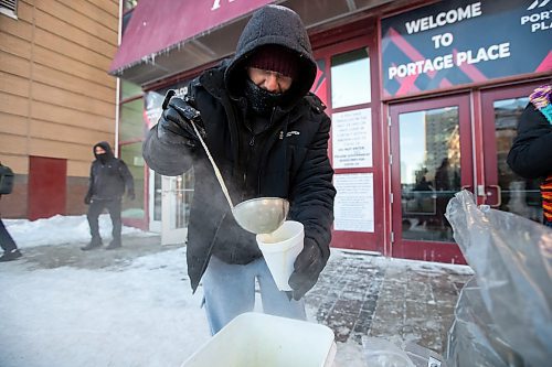 Daniel Crump / Winnipeg Free Press. Joshua Goddard, a volunteer with Warmer Hearts Winnipeg, ladles out some soup for person in need on Saturday afternoon in downtown Winnipeg. December 24, 2022.