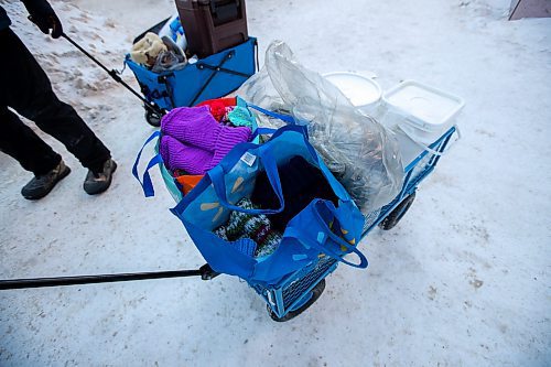 Daniel Crump / Winnipeg Free Press. Volunteers from Warmer Hearts Winnipeg hand out hot chocolate, soup, and clothing to anyone who wants some in downtown Winnipeg. December 24, 2022.