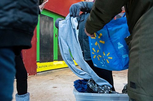 Daniel Crump / Winnipeg Free Press. Volunteers from Warmer Hearts Winnipeg hand out hot chocolate, soup, and clothing to anyone who wants some in downtown Winnipeg. December 24, 2022.