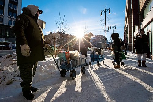 Daniel Crump / Winnipeg Free Press. Volunteers from Warmer Hearts Winnipeg hand out hot chocolate, soup, and clothing to anyone who wants some in downtown Winnipeg. December 24, 2022.