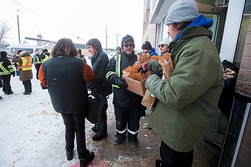 JOHN WOODS / WINNIPEG FREE PRESS
Lorne Proutt, centre, and other volunteers with the Bear Clan hand out warm clothing items and lunch to people outside the Salvation Army Sunday, December 25, 2022. The group hit several locations today hoping to reach as many people as possible.

Re: Abas