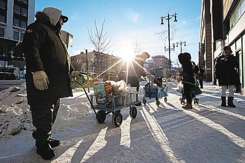 Daniel Crump / Winnipeg Free Press. Volunteers from Warmer Hearts Winnipeg hand out hot chocolate, soup, and clothing to anyone who wants some in downtown Winnipeg. December 24, 2022.