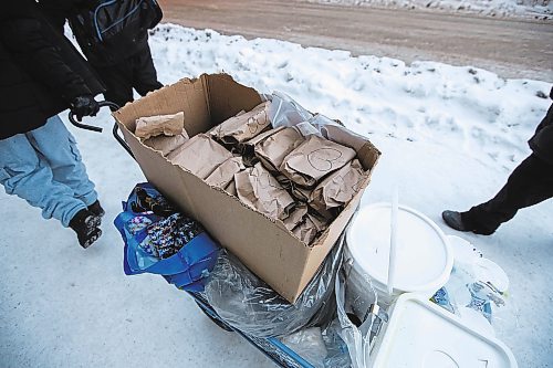 Daniel Crump / Winnipeg Free Press. Volunteers from Warmer Hearts Winnipeg hand out hot chocolate, soup, and clothing to anyone who wants some in downtown Winnipeg. December 24, 2022.