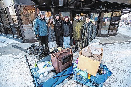 Daniel Crump / Winnipeg Free Press. Josh Maxwell (left), Nicole Wiebe, Marc Sweet, Joshua Goddard, Quentin Gabriel and Daniel Peterson are volunteers from Warmer Hearts Winnipeg. The group is spending Saturday afternoon handing out hot chocolate, warm soup, and clothing to anyone in need in downtown Winnipeg. December 24, 2022.