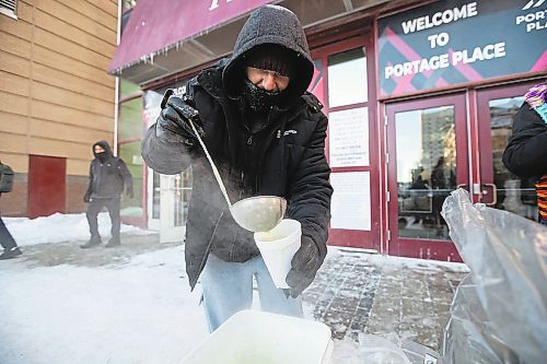 Daniel Crump / Winnipeg Free Press. Joshua Goddard, a volunteer with Warmer Hearts Winnipeg, ladles out some soup for person in need on Saturday afternoon in downtown Winnipeg. December 24, 2022.