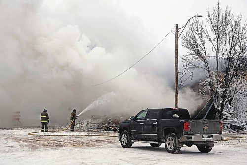 Firefighters spray waters on the embers of a fire that destroyed the Gladstone Hotel on the afternoon of Dec. 25. (Colin Slark/The Brandon Sun)
