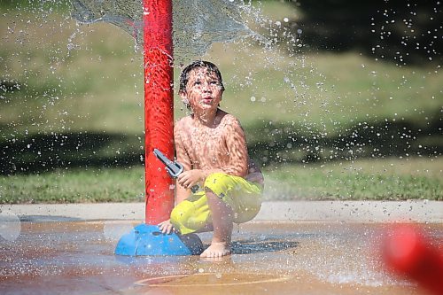 Six-year-old Leon McLenon watches the water spray at the Rideau water park on a sunny and hot afternoon. (Matt Goerzen/The Brandon Sun)