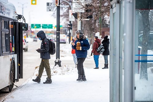 MIKAELA MACKENZIE / WINNIPEG FREE PRESS

Frank Zhang gets on his bus at a downtown Winnipeg Transit stop on Main Street at Broadway on Tuesday, Dec. 27, 2022. For Tyler story.
Winnipeg Free Press 2022.