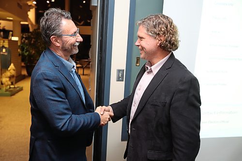 26102022
Jeff Fawcett shakes hands with outgoing Mayor Rick Chrest while awaiting the official results of his mayoral win in Brandon&#x2019;s municipal election at the Riverbank Discovery Centre on Wednesday evening.  
(Tim Smith/The Brandon Sun)

