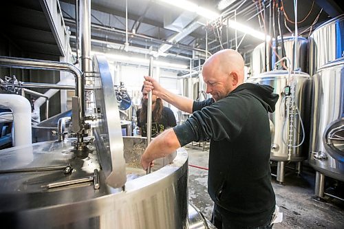 MIKAELA MACKENZIE / WINNIPEG FREE PRESS

Drinks writer Ben Sigurdson stirs the malt into the water for the initial mash while brewing the Free Press 150th anniversary beer at Nonsuch Brewing Co. in Winnipeg on Monday, July 25, 2022. For Ben Sigurdson story.
Winnipeg Free Press 2022.