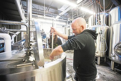 MIKAELA MACKENZIE / WINNIPEG FREE PRESS

Drinks writer Ben Sigurdson stirs the malt into the water for the initial mash while brewing the Free Press 150th anniversary beer at Nonsuch Brewing Co. in Winnipeg on Monday, July 25, 2022. For Ben Sigurdson story.
Winnipeg Free Press 2022.