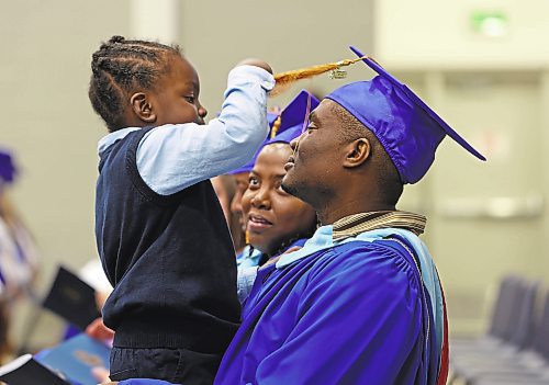 Brandon Sun Three year old K'Mor Morgan plays with their father Rurian Morgan's graduation tassle while his mother Natashalee Thompson &#x2014;&#xa4;who is also graduating &#x2014;&#xa4;looks at K'Mor during afternoon convocation services at the Brandon University Health Living Centre on Thursday afternoon. Both Rurian and Natashalee graduated from BU's Faculty of Education on Thursday. (Matt Goerzen/The Brandon Sun)