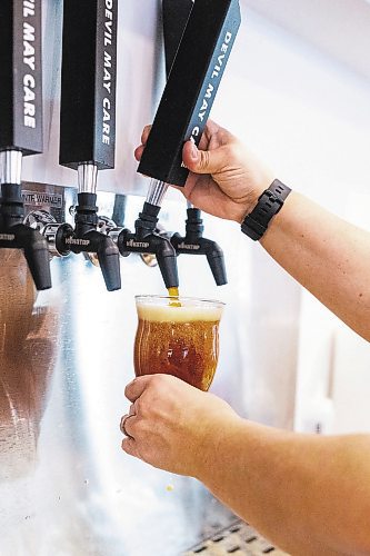 MIKAELA MACKENZIE / WINNIPEG FREE PRESS

Frances Gauthier pours a beer at the Devil May Care taproom, which opened December 23rd at Fort Street and York Avenue, in Winnipeg on Wednesday, Dec. 28, 2022. For Marty Cash story.
Winnipeg Free Press 2022.