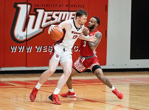 JESSICA LEE / WINNIPEG FREE PRESS

University of Winnipeg Wesmen player Donald Stewart (13) dribbles the ball while University of Algoma Thunderbirds player Patrick-Olivier Mpoyi (3) plays defence during a game at the Duckworth Centre on December 28, 2022.

Reporter: Mike Sawatzky