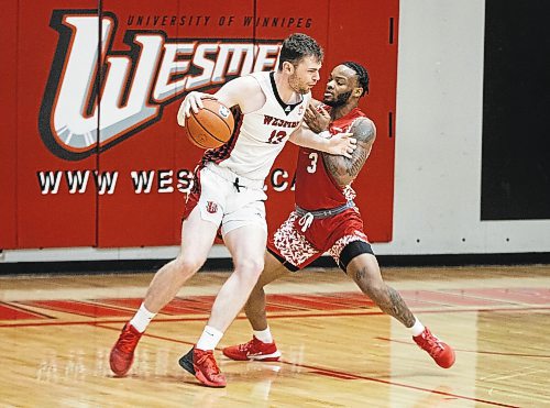 JESSICA LEE / WINNIPEG FREE PRESS

University of Winnipeg Wesmen player Donald Stewart (13) dribbles the ball while University of Algoma Thunderbirds player Patrick-Olivier Mpoyi (3) plays defence during a game at the Duckworth Centre on December 28, 2022.

Reporter: Mike Sawatzky