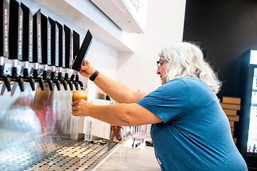 MIKAELA MACKENZIE / WINNIPEG FREE PRESS

Frances Gauthier pours a beer at the Devil May Care taproom, which opened December 23rd at Fort Street and York Avenue, in Winnipeg on Wednesday, Dec. 28, 2022. For Marty Cash story.
Winnipeg Free Press 2022.