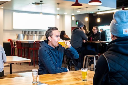 MIKAELA MACKENZIE / WINNIPEG FREE PRESS

Ryan Van Berkel enjoys a beer at the Devil May Care taproom, which opened December 23rd at Fort Street and York Avenue, in Winnipeg on Wednesday, Dec. 28, 2022. For Marty Cash story.
Winnipeg Free Press 2022.