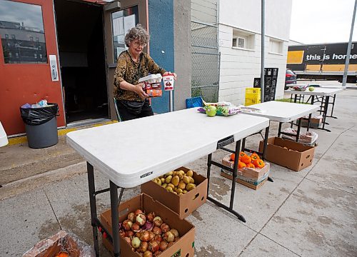 MIKE DEAL / WINNIPEG FREE PRESS

Agape Table volunteer, Jackie Sakal, sets out food for a customer to pick up during their hamper hand-out, Thursday afternoon. 

The skyrocketing cost of food is creating a massive demand for those in need. 

see Malak Abas story

220714 - Thursday, July 14, 2022.