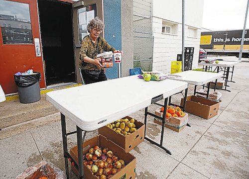 MIKE DEAL / WINNIPEG FREE PRESS

Agape Table volunteer, Jackie Sakal, sets out food for a customer to pick up during their hamper hand-out, Thursday afternoon. 

The skyrocketing cost of food is creating a massive demand for those in need. 

see Malak Abas story

220714 - Thursday, July 14, 2022.
