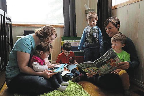 Left to right; Chantal Peters and her two children Annabeth and Jayden, share a reading circle with Elizabeth Cancade and her two sons Rafael and Ludo. (Joseph Bernacki/The Brandon Sun)