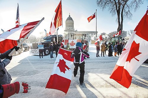 MIKE DEAL / WINNIPEG FREE PRESS
Annie Wiebe waves an upside-down Canadian flag at supporters as they drive by on Broadway during the Anti-Vaccine Mandate protest Friday morning.
Protesters block the entrance to the Manitoba Legislative building on Broadway and have parked their trucks along Memorial early Friday morning.
220204 - Friday, February 04, 2022.