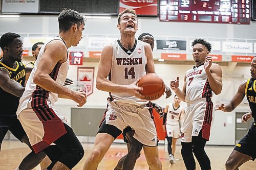 JESSICA LEE / WINNIPEG FREE PRESS

University of Winnipeg Wesmen player Mikhail Mikhailov (14) grabs the ball during a game against the University of Brandon Bobcats at Duckworth Centre on December 29, 2022.

Reporter: Mike Sawatzky