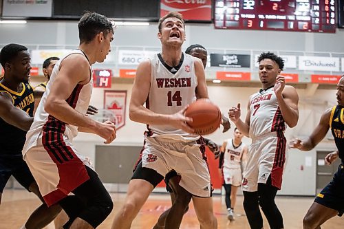 JESSICA LEE / WINNIPEG FREE PRESS

University of Winnipeg Wesmen player Mikhail Mikhailov (14) grabs the ball during a game against the University of Brandon Bobcats at Duckworth Centre on December 29, 2022.

Reporter: Mike Sawatzky