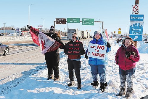 Brandon Sun Westman residents Ann Foote, Colleen Farmer, Cindy Kempthorne and Amanda Flannery show their support for the Freedom Rally convoy as it makes its way through Brandon on Tuesday morning. The group had to endure an extreme cold warning with temperatures that hovered around -30 C. (Kyle Darbyson/The Brandon Sun)