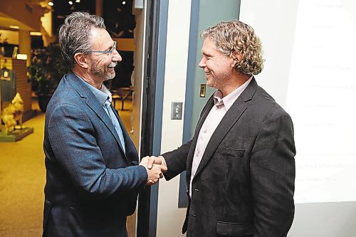 26102022
Jeff Fawcett shakes hands with outgoing Mayor Rick Chrest while awaiting the official results of his mayoral win in Brandon&#x2019;s municipal election at the Riverbank Discovery Centre on Wednesday evening.  
(Tim Smith/The Brandon Sun)
