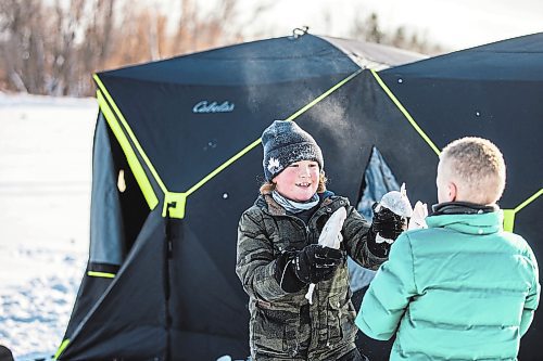 MIKAELA MACKENZIE / WINNIPEG FREE PRESS

Laine Hansen, eight, has a fish fight with a friend using fresh-caught sauger as weapons at an ice fishing village on the river in Lockport on Friday, Dec. 30, 2022. For Malak story.
Winnipeg Free Press 2022.