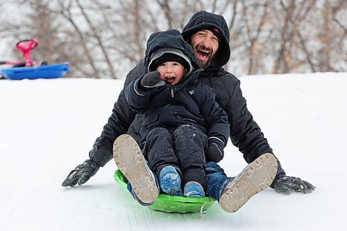 Jason Hlady and his four-year-old son toboggan together at Rideau Park in Brandon on an overcast Friday afternoon. (Tim Smith/The Brandon Sun)