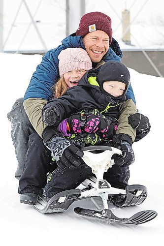 30122022
Kevin Roberts and his children Asher (front) and Addison (middle) slide down the hill at Rideau Park in Brandon together on an overcast Friday afternoon. (Tim Smith/The Brandon Sun)