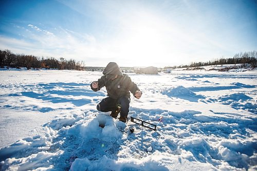 MIKAELA MACKENZIE / WINNIPEG FREE PRESS

Isaac Wolf sets a line in an ice fishing village on the river in Lockport on Friday, Dec. 30, 2022. For Malak story.
Winnipeg Free Press 2022.