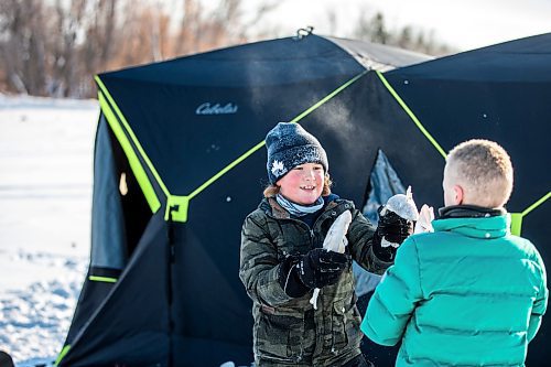 MIKAELA MACKENZIE / WINNIPEG FREE PRESS

Laine Hansen, eight, has a fish fight with a friend using fresh-caught sauger as weapons at an ice fishing village on the river in Lockport on Friday, Dec. 30, 2022. For Malak story.
Winnipeg Free Press 2022.