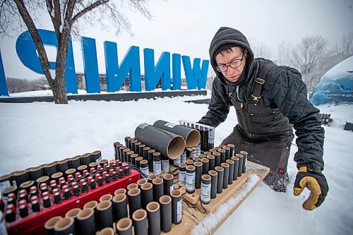 Daniel Crump / Winnipeg Free Press. Toby Hughes, a pyrotechnic technician from Archangel Fireworks, helps prepare a new year&#x573; eve display at the Forks in Winnipeg, Saturday afternoon. December 31, 2022.