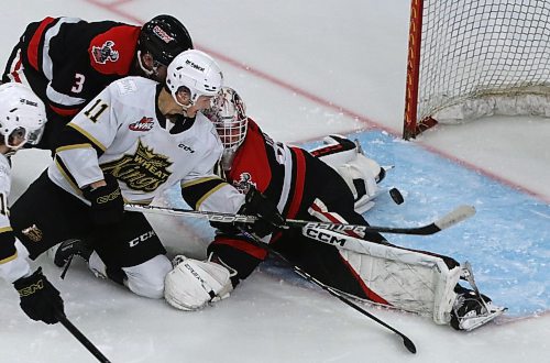 Brandon Wheat Kings forward Rylen Roersma (11) tries to get his stick on a bouncing puck in front of Moose Jaw Warriors goalie Connor Ungar (32) as defenceman Lucas Brenton (3) defends during the third period of Moose Jaw&#x2019;s 6-2 victory in Western Hockey League action at Westoba Place on Saturday. (Perry Bergson/The Brandon Sun)