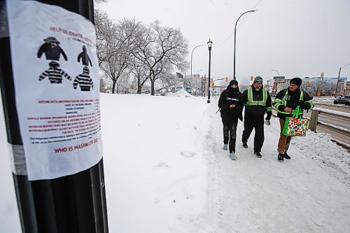 JOHN WOODS / WINNIPEG FREE PRESS
George Robinson right, and Darryl Contois, centre, distribute posters to help identify Buffalo Woman, an unidentified person who police have said was killed by an alleged serial killer in Winnipeg, on Main Street near Higgins Sunday, January 1, 2023. The hope is to gain information from the local community that will help identify Buffalo Woman.

Re: pindera