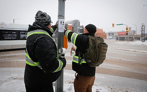 JOHN WOODS / WINNIPEG FREE PRESS
George Robinson, right, and Darryl Contois distribute posters to help identify Buffalo Woman, an unidentified person who police have said was killed by an alleged serial killer in Winnipeg, on Main Street near Higgins Sunday, January 1, 2023. The hope is to gain information from the local community that will help identify Buffalo Woman.

Re: pindera