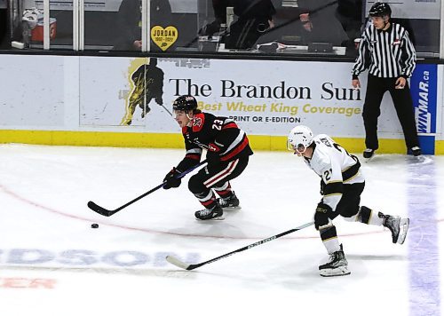 Moose Jaw Warriors forward Atley Calvert (23) skates through the neutral zone with Brandon Wheat Kings forward Tony Wilson (21) in hot pursuit during Moose Jaw’s 6-2 win in Western Hockey League action at Westoba Place on Saturday. (Perry Bergson/The Brandon Sun)