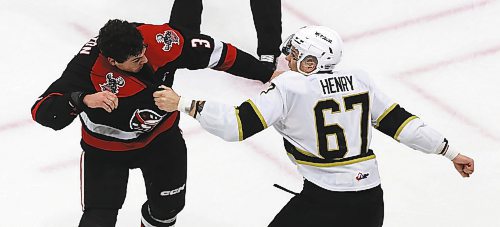 Brandon Wheat Kings forward Matt Henry (67) prepares to throw another punch at Moose Jaw Warriors defenceman Lucas Brenton (3) during a first period tilt in Moose Jaw&#x2019;s 6-2 victory in Western Hockey League action at Westoba Place on Saturday. (Perry Bergson/The Brandon Sun)