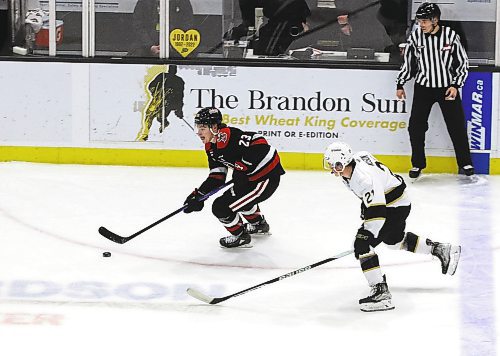 Moose Jaw Warriors forward Atley Calvert (23) skates through the neutral zone with Brandon Wheat Kings forward Tony Wilson (21) in hot pursuit during Moose Jaw&#x2019;s 6-2 win in Western Hockey League action at Westoba Place on Saturday. (Perry Bergson/The Brandon Sun)