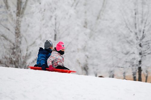 JOHN WOODS / WINNIPEG FREE PRESS
Dax, 7, and Aurelia, 5, slide down a hill with frosty tress as a background as they take part in Arctic Glacier Winter Park events at the Forks Sunday, January 1, 2023. 

Re: ?