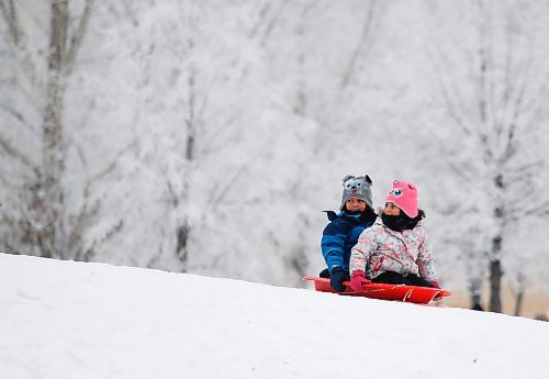 JOHN WOODS / WINNIPEG FREE PRESS
Dax, 7, and Aurelia, 5, slide down a hill with frosty tress as a background as they take part in Arctic Glacier Winter Park events at the Forks Sunday, January 1, 2023. 

Re: ?