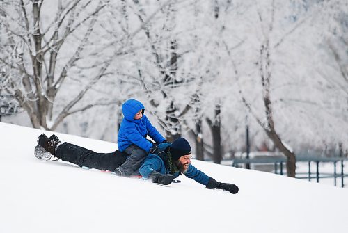 JOHN WOODS / WINNIPEG FREE PRESS
David Litke and son Tristan slide down a hill with frosty tress as a background as they take part in Arctic Glacier Winter Park events at the Forks Sunday, January 1, 2023. 

Re: ?