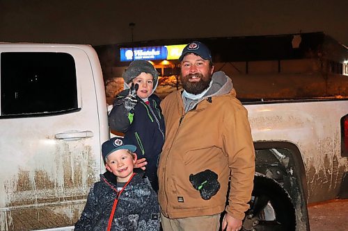 Westman resident Dustin Harvey poses for a photo alongside his sons Maverick and Stellan Saturday evening following a fireworks display that took place outside Brandon's Keystone Centre. Harvey, who lives on an acreage near Rapid City, told the Sun that his kids missed out on alot of events like this due to the pandemic and is hoping that changes in the new year. (Kyle Darbyson/The Brandon Sun)  