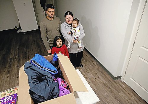 Rocio Luna (on the right holding her son Muhammad) moved with her family to Canada from Mexico to study at Brandon University but was unprepared for the cold. When she asked for help finding warm clothing on a Facebook group, people offered both guidance and clothing. Luna's husband, Qamar, and daughter, Amina are on the left. (Ian Hitchen/The Brandon Sun)