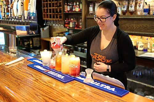 Connie Blair, server at The Dock on Princess in Brandon, makes non-alcoholic drinks, also known as mocktails, at the restaurant Tuesday. (Michele McDougall/The Brandon Sun)   