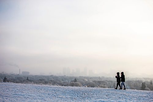 MIKAELA MACKENZIE / WINNIPEG FREE PRESS

Angelica Erasmo (left) and Aaron Musngi watch from Garbage Hill as the sun rises and ice fog hangs over the city in Winnipeg on Tuesday, Jan. 3, 2023. Standup.
Winnipeg Free Press 2022.