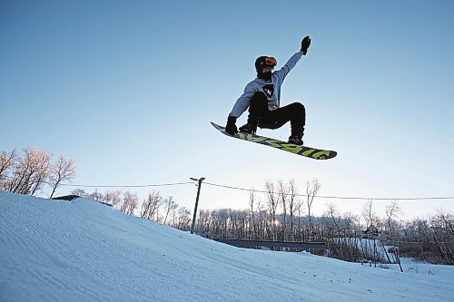 03012023
A snowboarder sails off a box in the terrain park at Asessippi Ski Resort on a sunny Tuesday. (Tim Smith/The Brandon Sun)