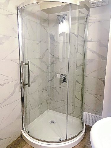 Photos by Marc LaBossiere / Winnipeg Free Press
A corner shower stall with rounded base and sliding glass shower door replaces the old unit, which was grungy and dated
